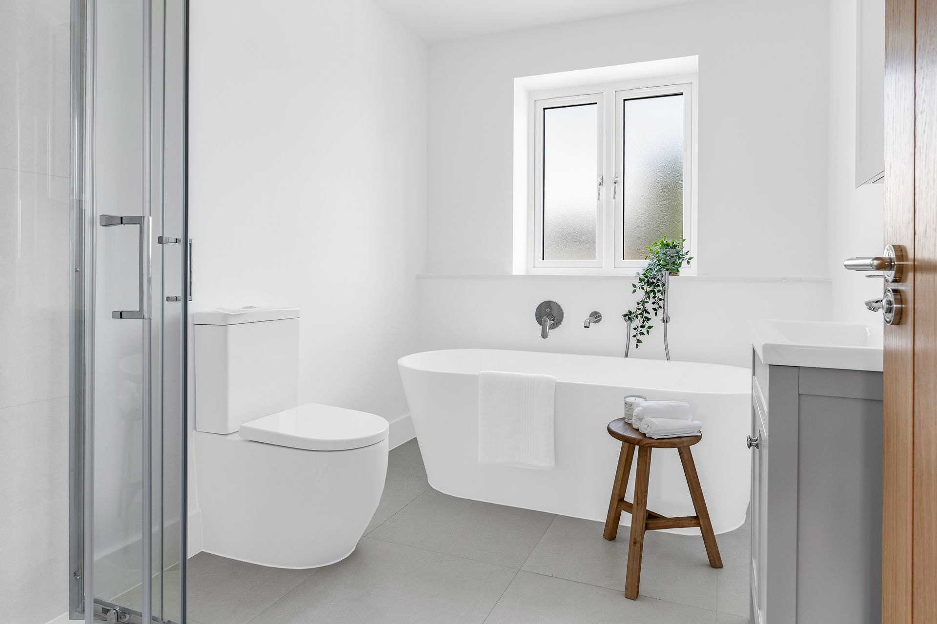 Bright bathroom with a freestanding bath and walk-in shower.